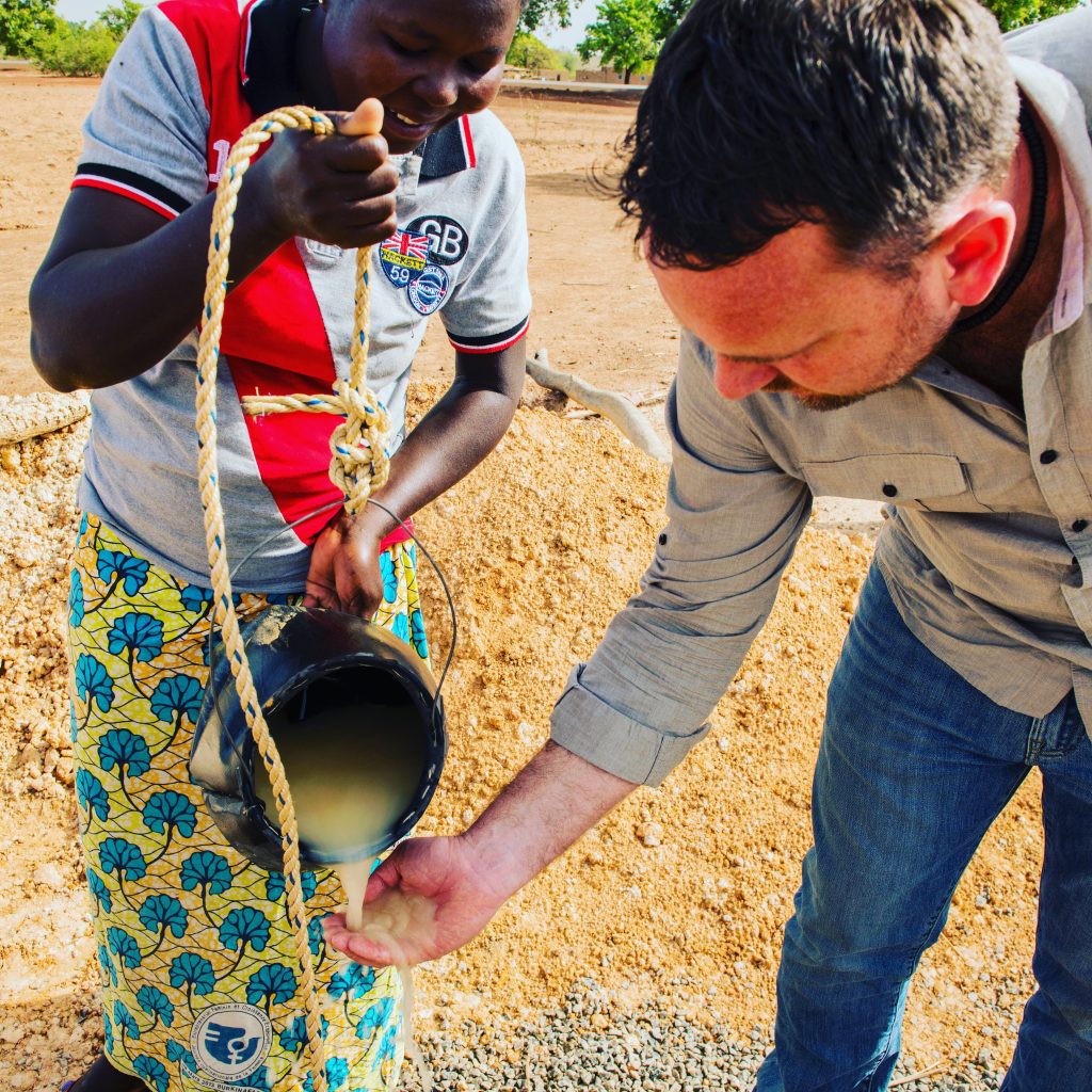 Have You Told the Man We Haven't Eaten? Tim looking at well water in Burkina